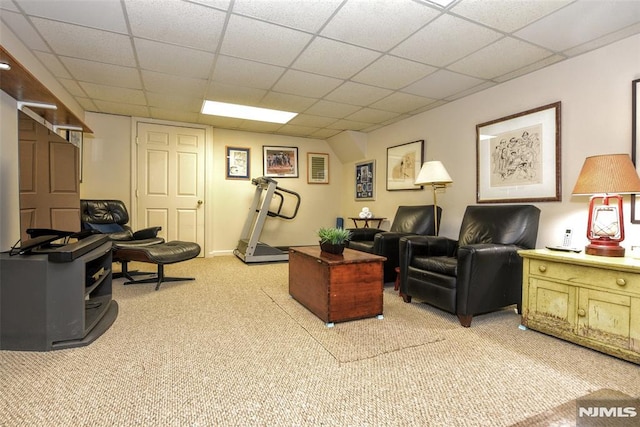 living room featuring a paneled ceiling and light carpet