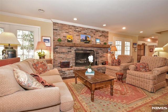 living room with ornamental molding and a brick fireplace