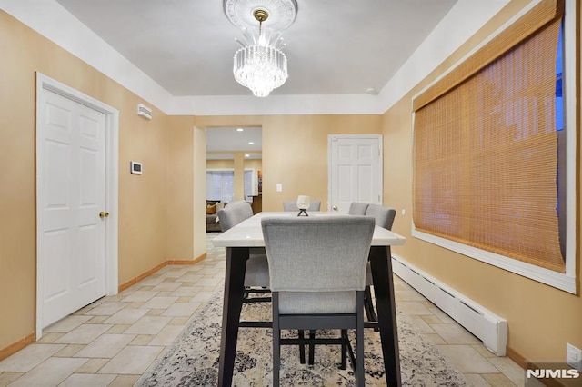 dining area with a chandelier and a baseboard radiator