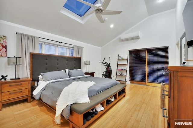 bedroom featuring light hardwood / wood-style floors, a wall mounted air conditioner, vaulted ceiling with skylight, ornamental molding, and ceiling fan