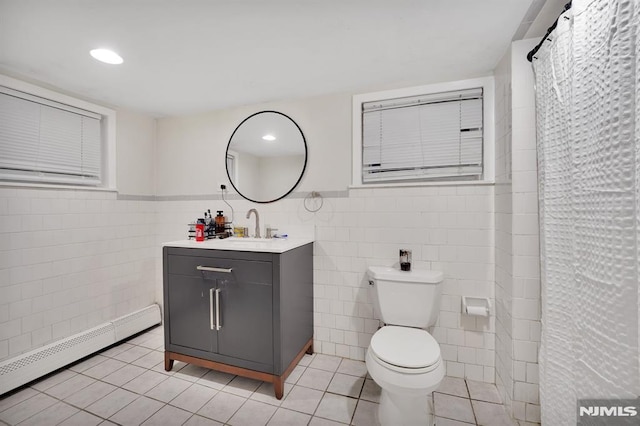 bathroom with tile walls, tile patterned flooring, and a baseboard heating unit