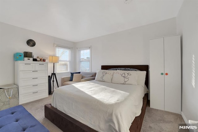 bedroom featuring light carpet