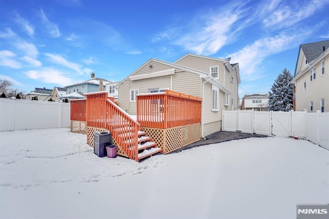 snow covered property with a deck