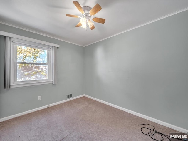 spare room with carpet floors, ceiling fan, and ornamental molding