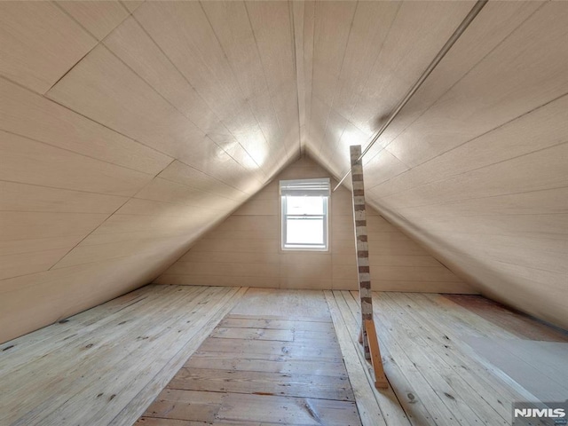 additional living space featuring light hardwood / wood-style floors and vaulted ceiling