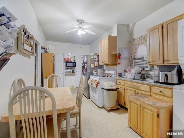 kitchen with light brown cabinets, sink, ceiling fan, white range with gas cooktop, and stainless steel refrigerator