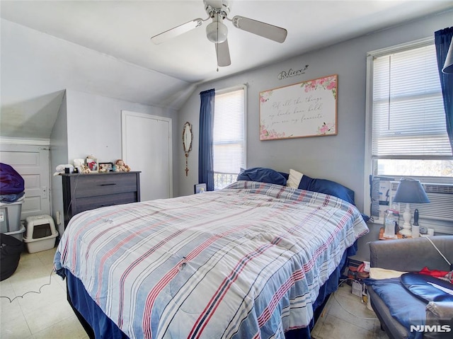 bedroom with multiple windows, vaulted ceiling, and ceiling fan