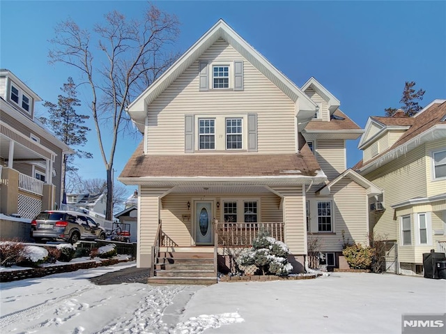 view of front of house featuring a shingled roof and a porch