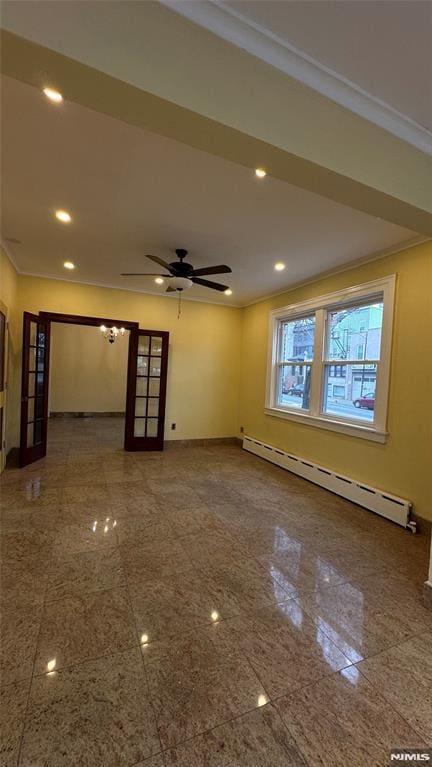 unfurnished living room with french doors, baseboard heating, ceiling fan, and ornamental molding