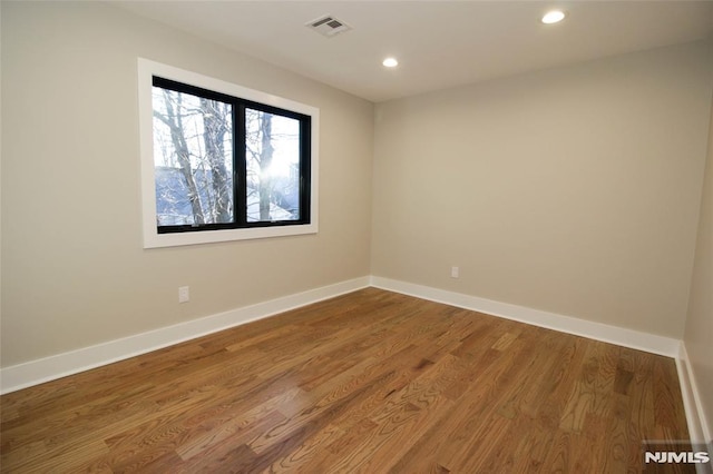 spare room featuring hardwood / wood-style floors