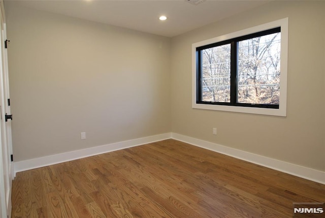 spare room with wood-type flooring