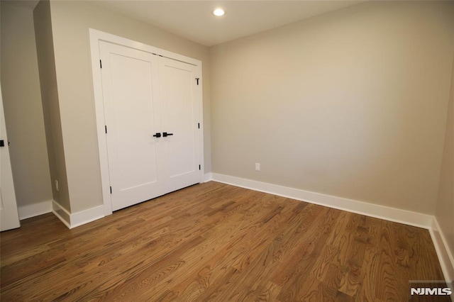 unfurnished bedroom featuring hardwood / wood-style flooring