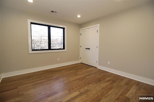 empty room featuring dark hardwood / wood-style flooring