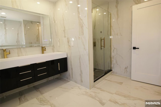 bathroom featuring vanity and a shower with shower door