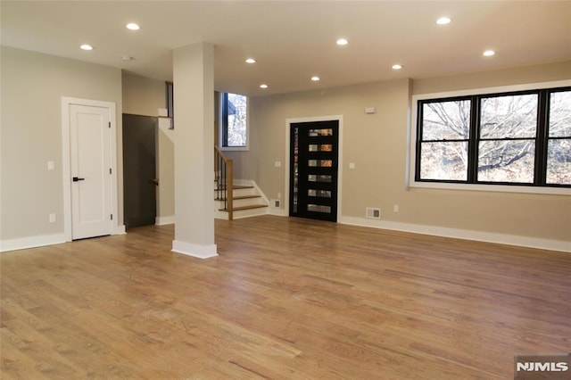 unfurnished living room featuring light wood-type flooring