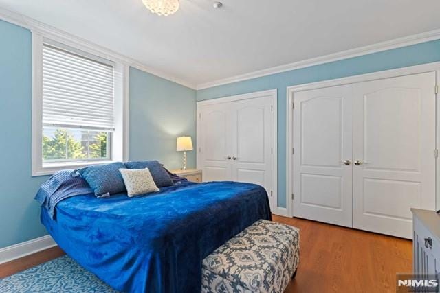 bedroom featuring hardwood / wood-style floors and crown molding