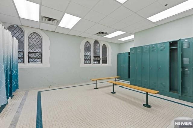 exercise area featuring a paneled ceiling