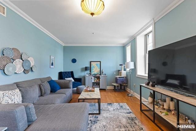 living room featuring ornamental molding and light hardwood / wood-style flooring