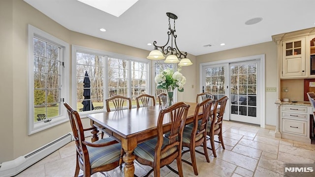 dining room featuring a notable chandelier, baseboard heating, french doors, and a wealth of natural light