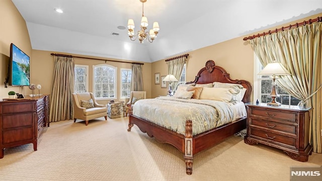 bedroom with lofted ceiling, a chandelier, and light carpet