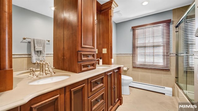 full bathroom featuring tile patterned flooring, toilet, vanity, tile walls, and a baseboard radiator