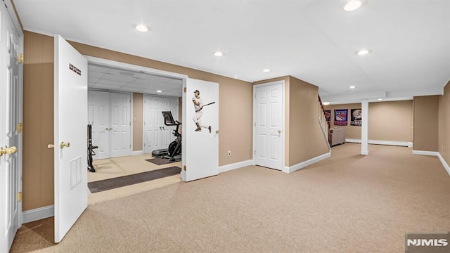 exercise room featuring light carpet