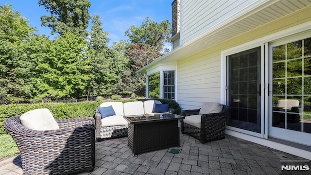 view of patio / terrace featuring an outdoor living space with a fire pit