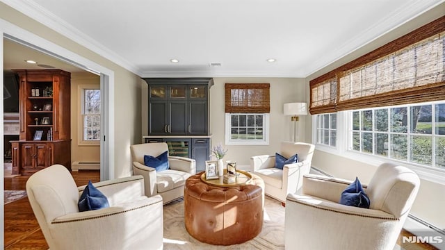 living area with dark wood-type flooring, a baseboard radiator, and crown molding