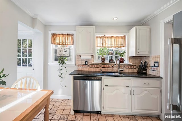 kitchen with white cabinets, stainless steel dishwasher, decorative backsplash, and sink