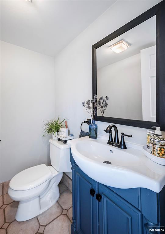 bathroom featuring toilet and vanity