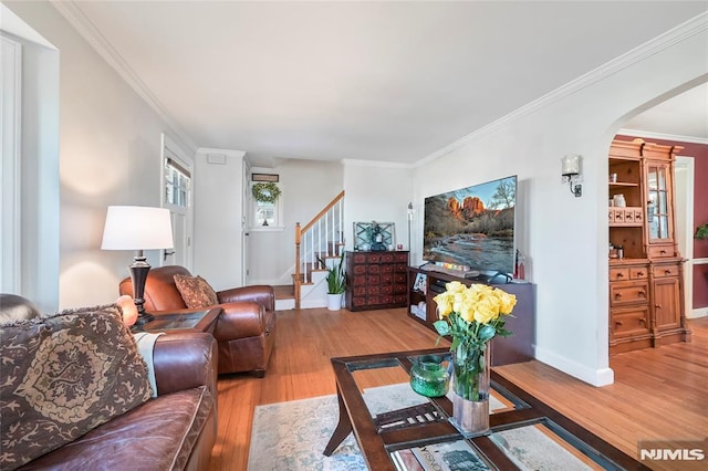 living room with hardwood / wood-style flooring and ornamental molding