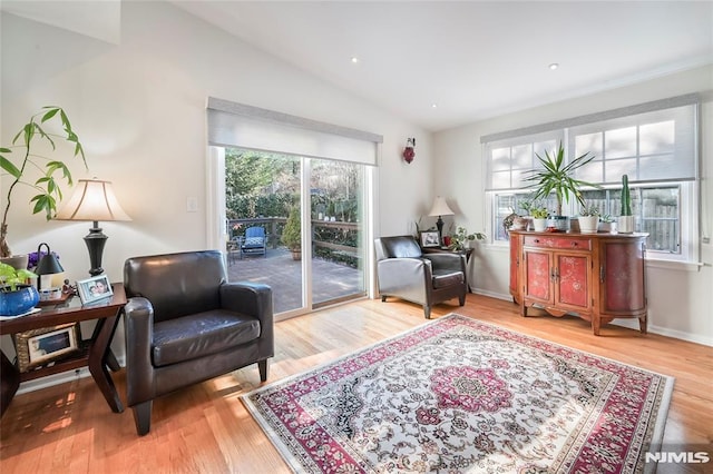 sitting room featuring hardwood / wood-style floors and vaulted ceiling