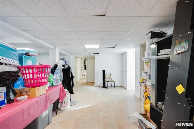 basement featuring a paneled ceiling