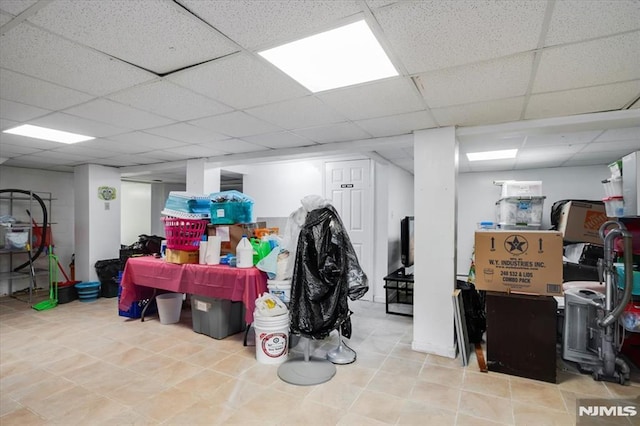 basement featuring a paneled ceiling