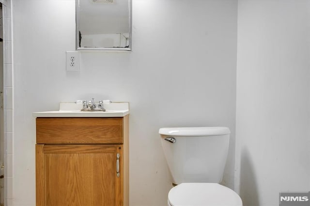 bathroom with toilet and vanity