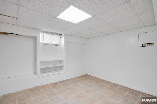 basement featuring a drop ceiling