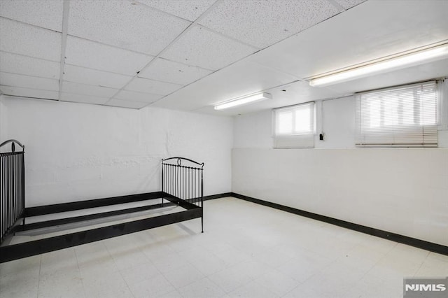 basement featuring a drop ceiling