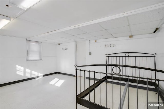 hallway featuring a drop ceiling