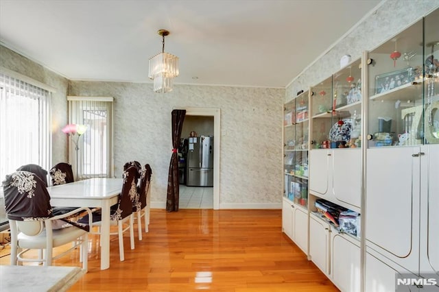 dining room featuring a chandelier and light hardwood / wood-style flooring