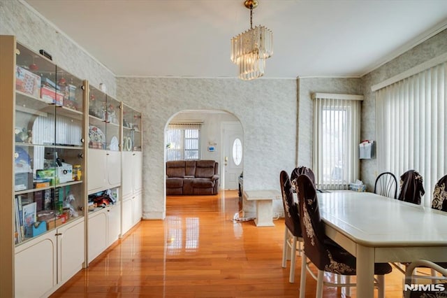 dining area with light wood-type flooring and a chandelier