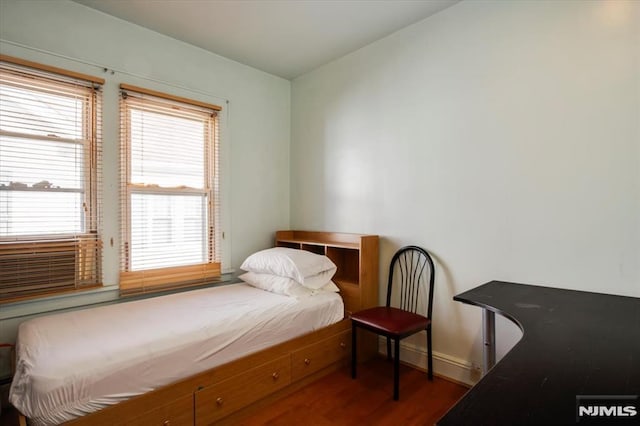 bedroom featuring dark wood-type flooring