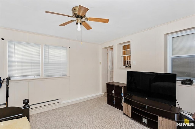 misc room featuring a baseboard heating unit, light colored carpet, ceiling fan, and crown molding