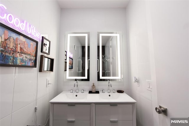 bathroom with tile walls and vanity