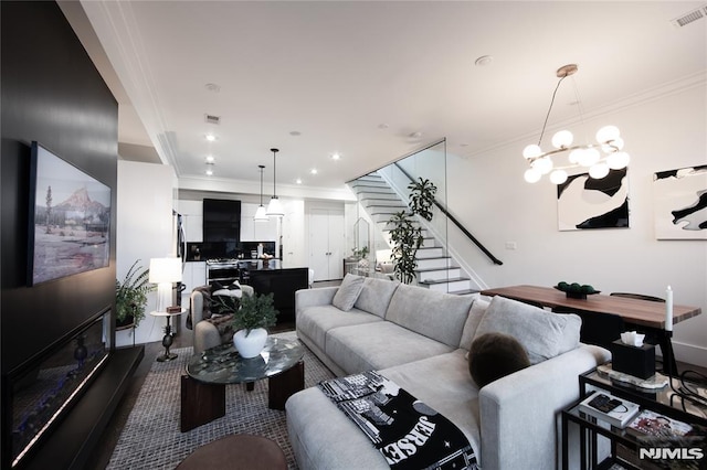 living room featuring crown molding and an inviting chandelier