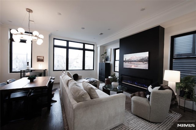 living room featuring crown molding, a chandelier, and hardwood / wood-style floors