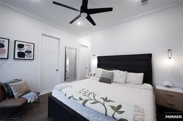 bedroom featuring ceiling fan, crown molding, and dark hardwood / wood-style floors