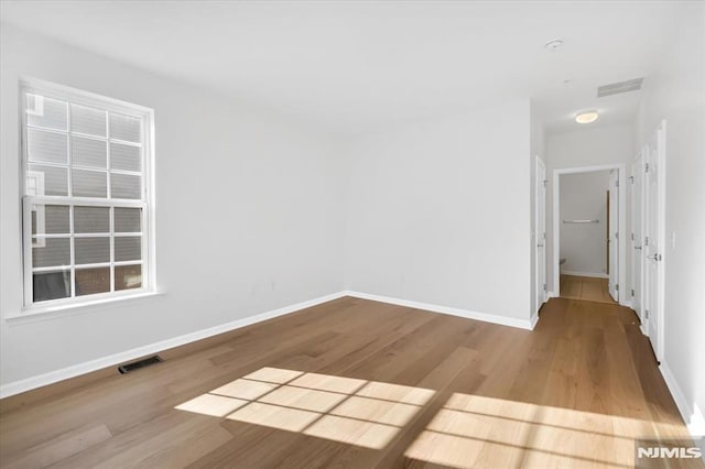 spare room with light hardwood / wood-style floors