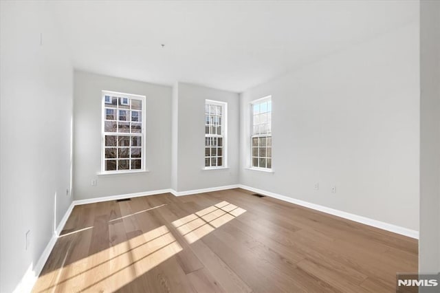 spare room with hardwood / wood-style flooring