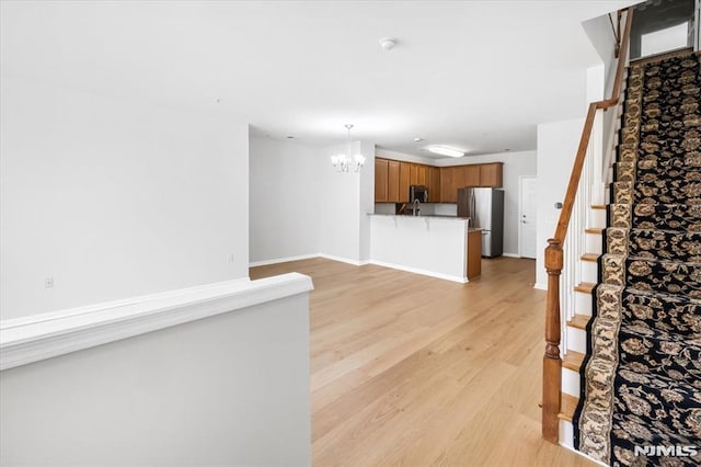 interior space featuring a chandelier and light hardwood / wood-style flooring