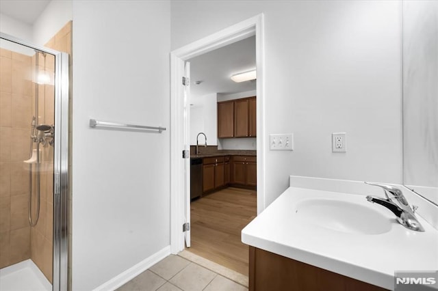 bathroom with tile patterned flooring, an enclosed shower, and vanity